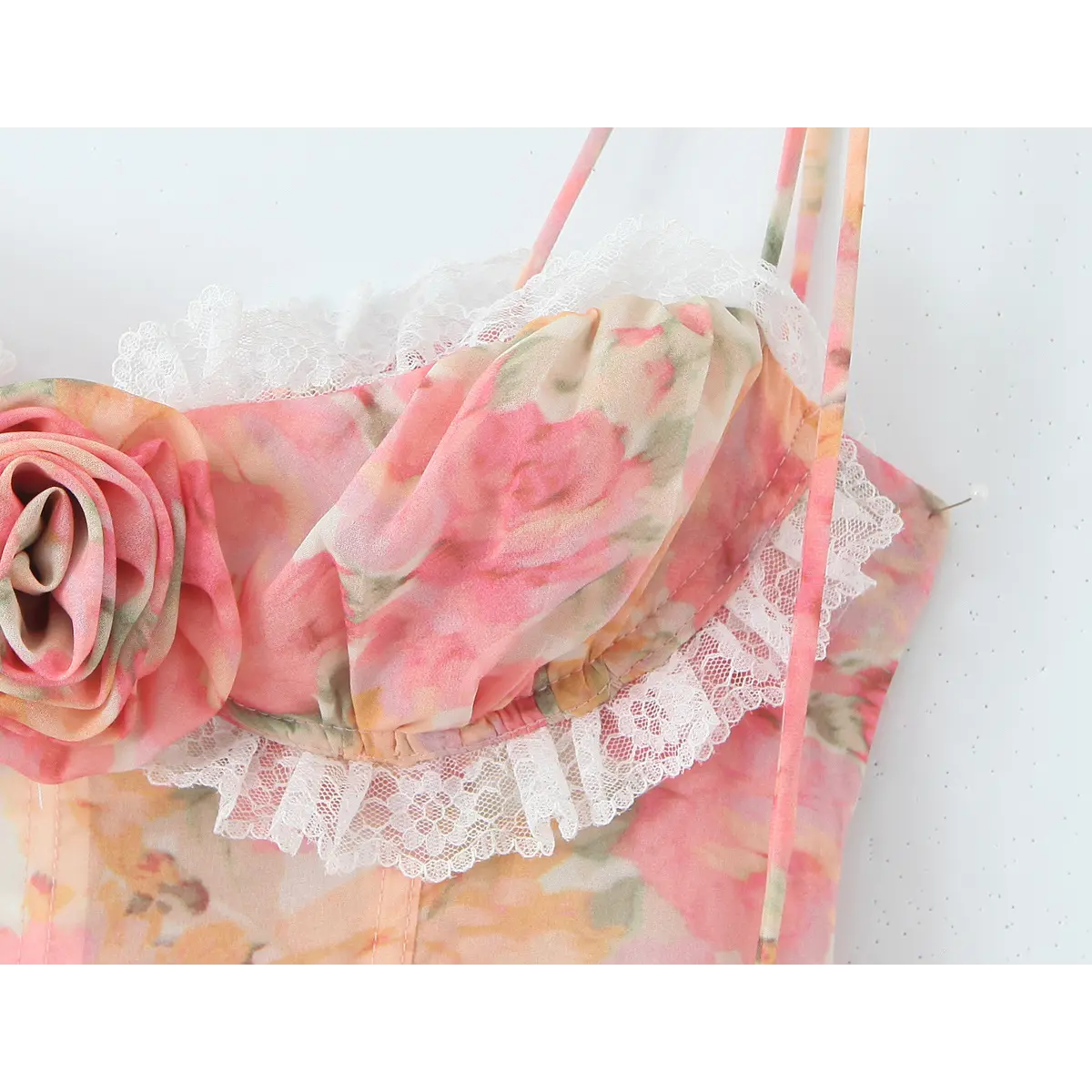 Close-up of the sweetheart neckline, delicate lace trim, gathered fabric, and the 3D fabric rose appliqué.