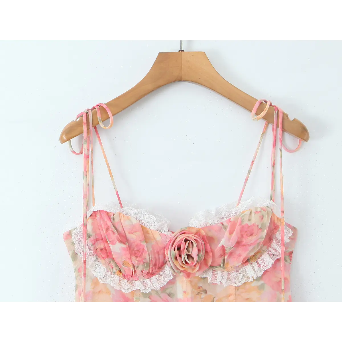Close-up of the multi-strand spaghetti straps, which are tied and adjustable, matching the floral print.