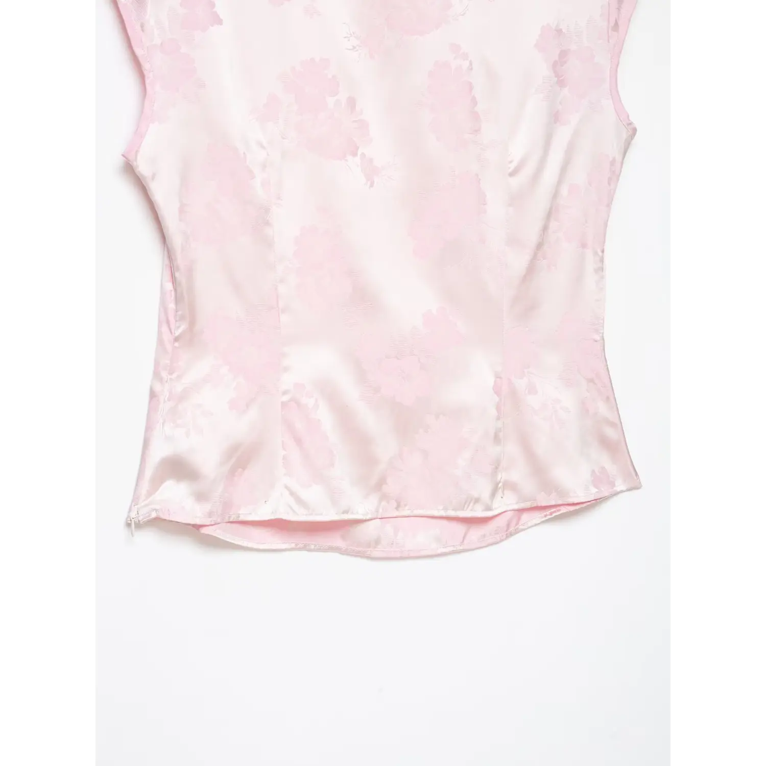 Back partial shot, light pink floral jacquard sleeveless blouse, vertical princess seams, finished curved hem, inner lining detail