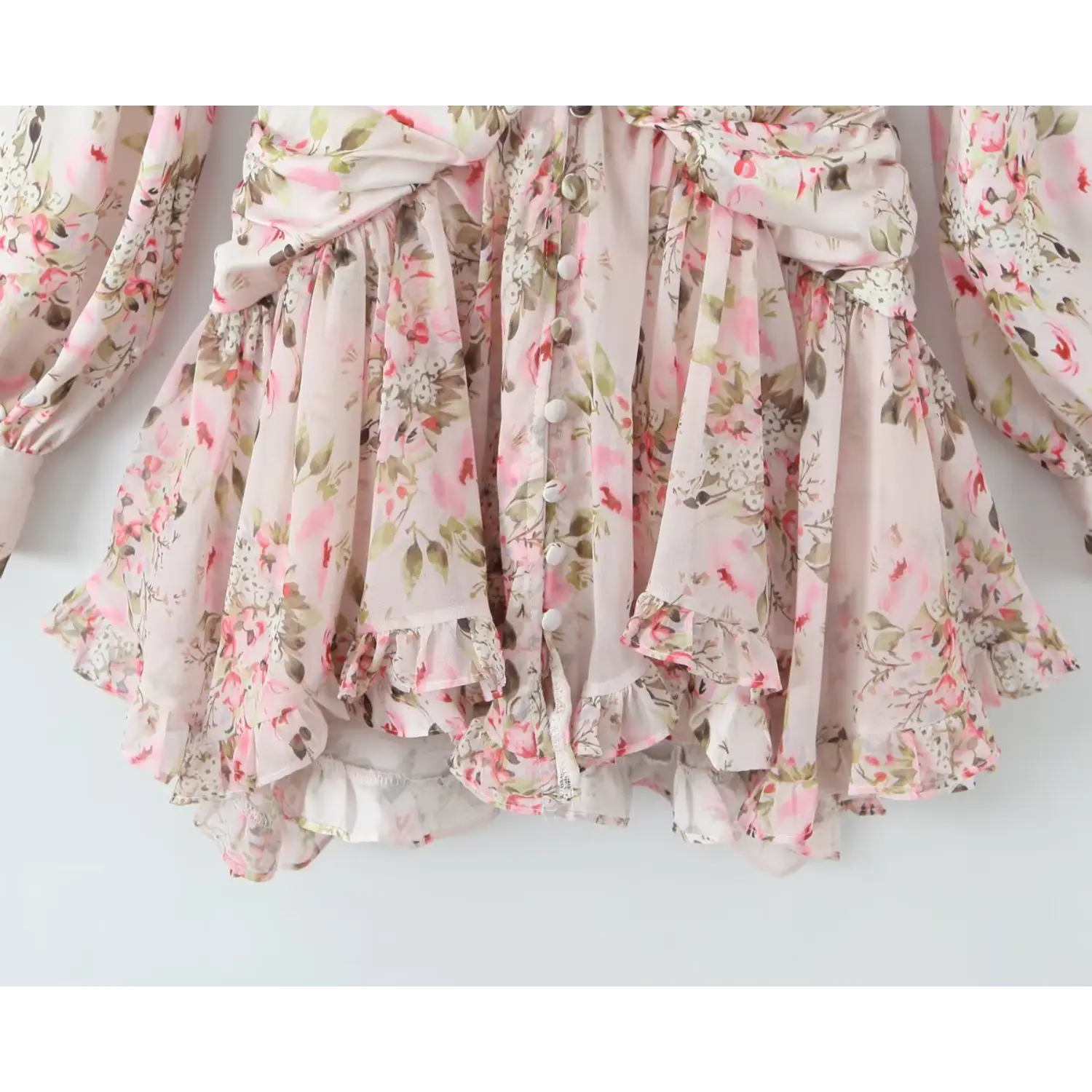 Full skirt overview of pink floral chiffon mini dress, tiered ruffle layers and front button placket