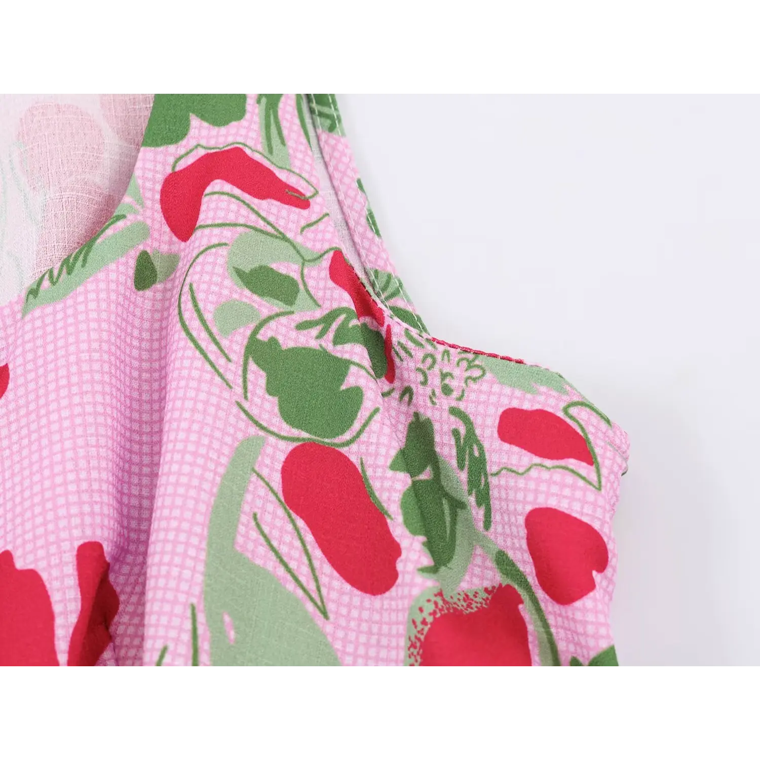 Fabric pattern closeup of pink floral fruit print sleeveless crop top