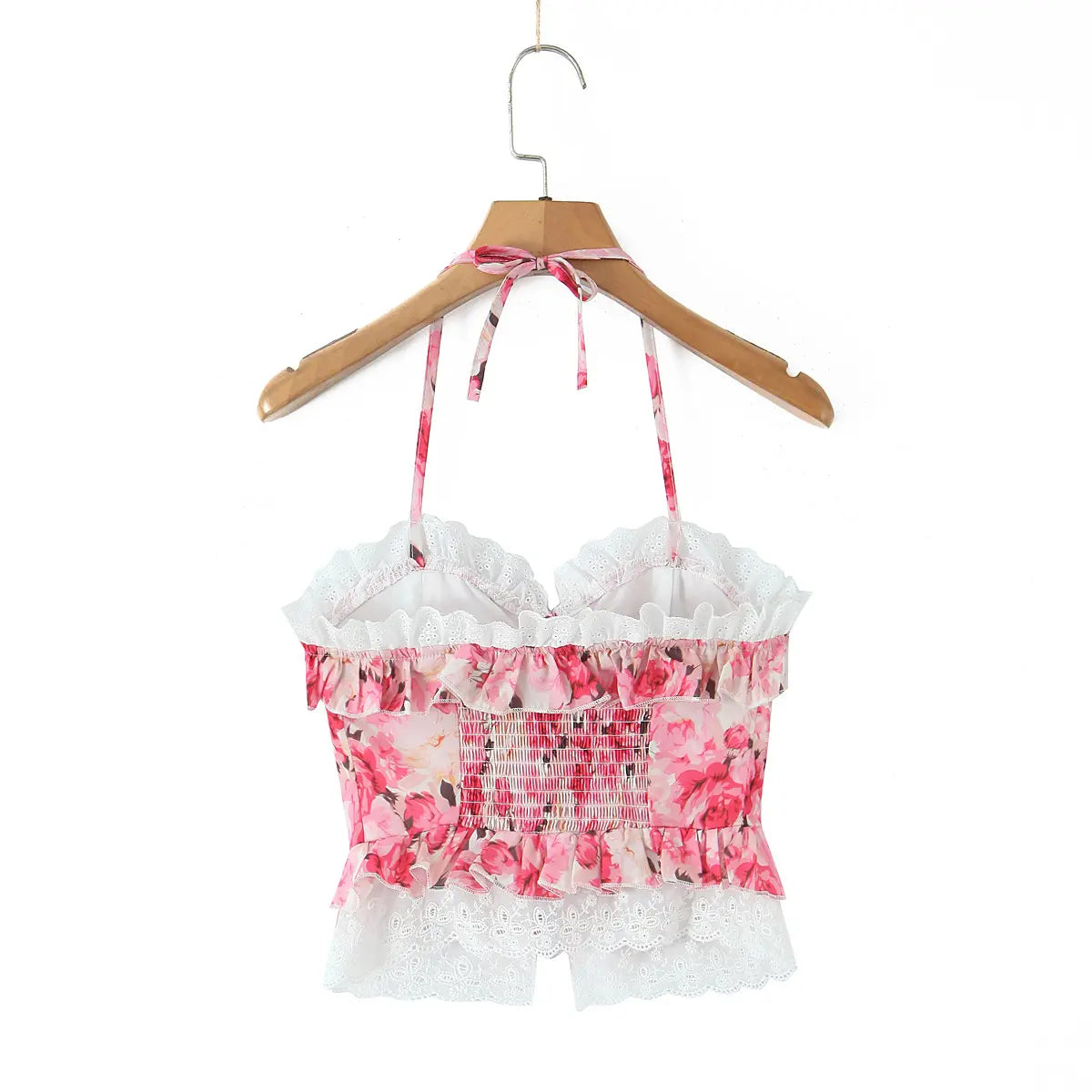 Back view of the pink floral halter corset top on a wooden hanger, showing the back construction.