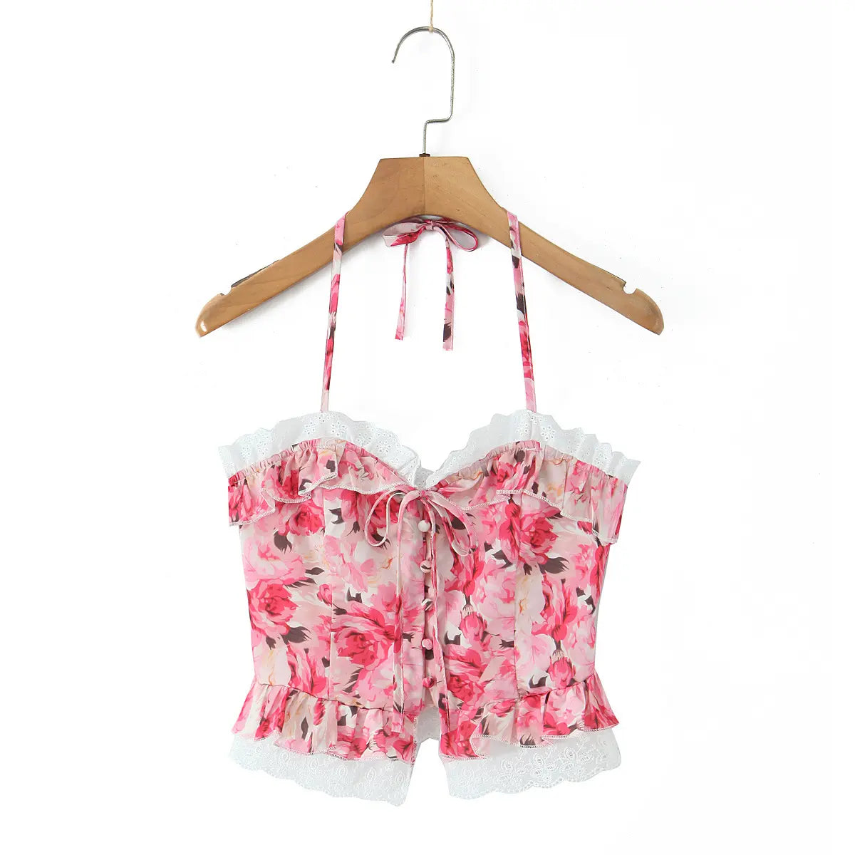 Front view of the pink floral halter corset top on a wooden hanger.