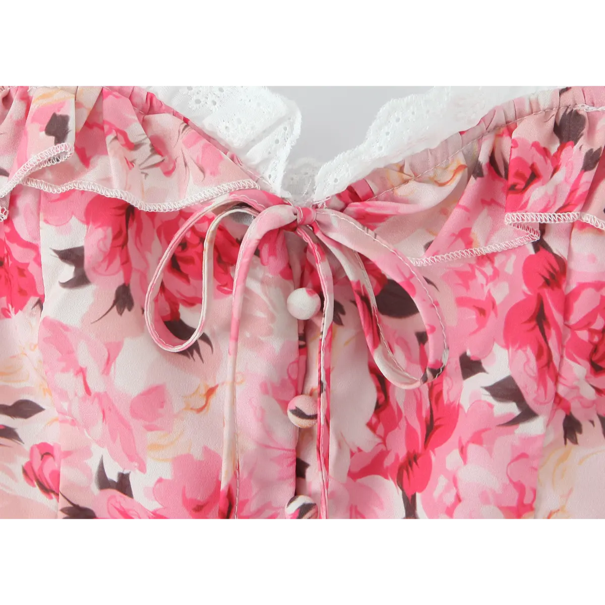 Close-up of the front drawstring tie and gathered bust detail on the pink halter corset top.