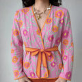Female model wearing pink floral embroidery V-neck wrap kimono jacket with orange tie belt