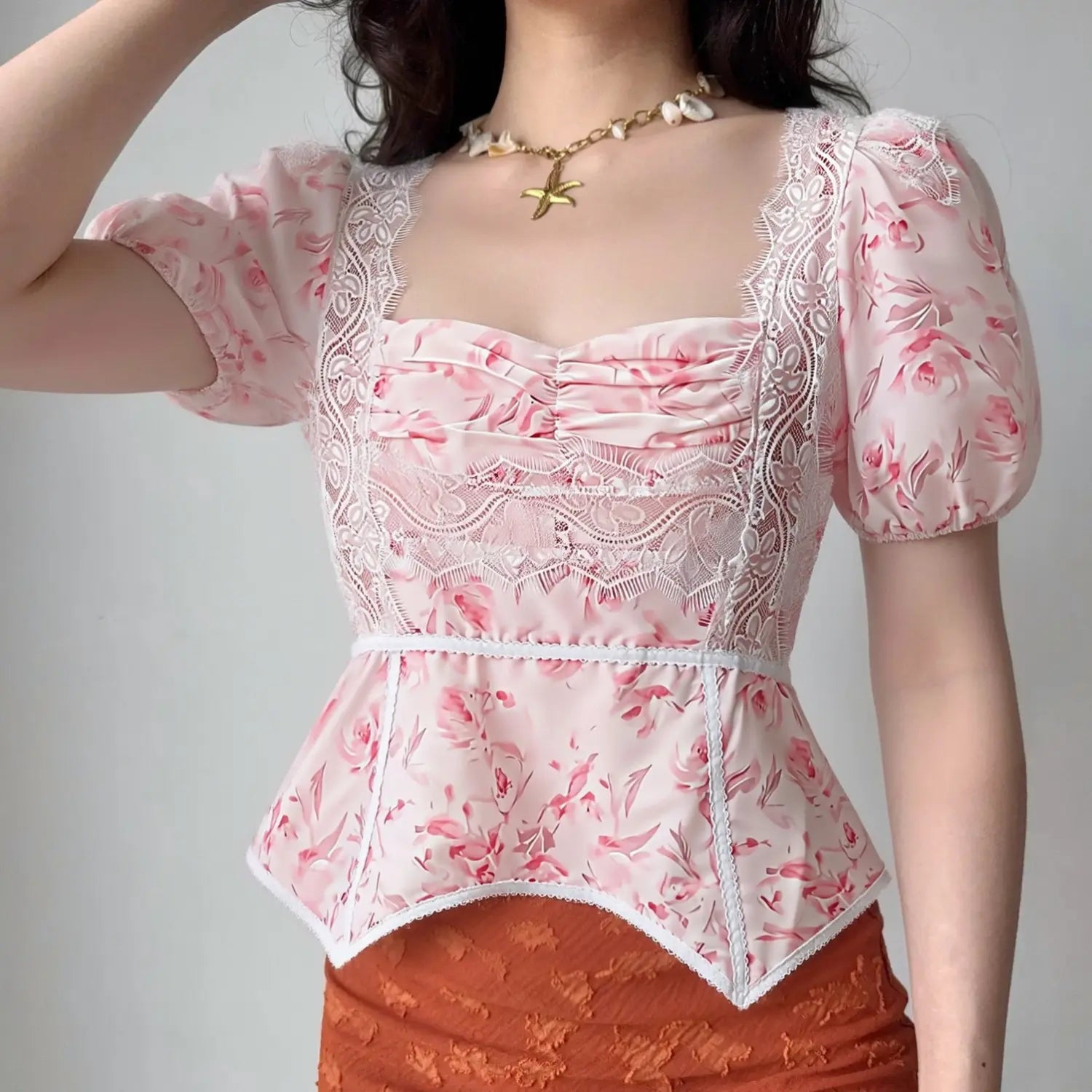 Female model wearing pink floral square neck lace trim puff sleeve peplum blouse