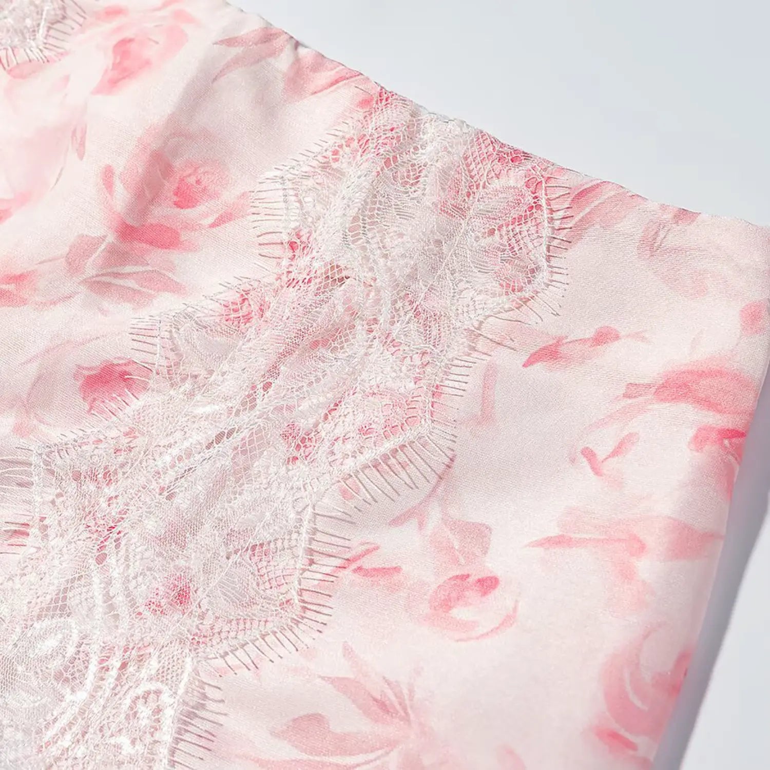 Macro detail pink watercolor rose print fabric and white lace trim