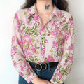 Front lifestyle shot on model, floral satin lapel blouse, matched with jeans and black belt, vintage casual outfit