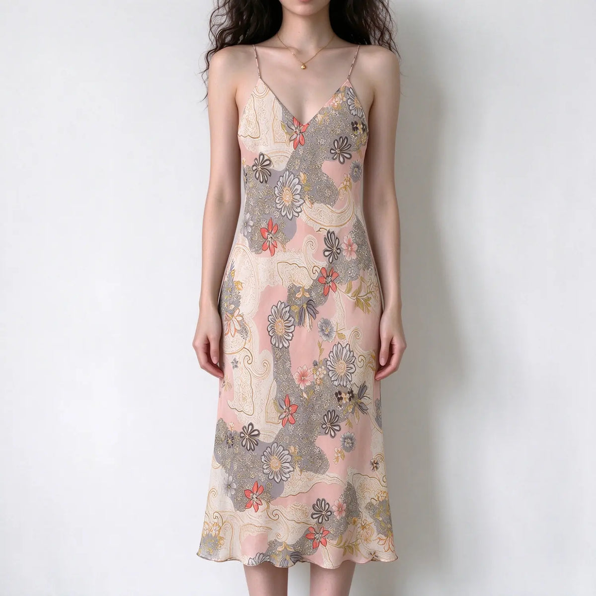 Model wearing pink vintage floral spaghetti strap maxi slip dress, v neck, bias cut flowy skirt, white background