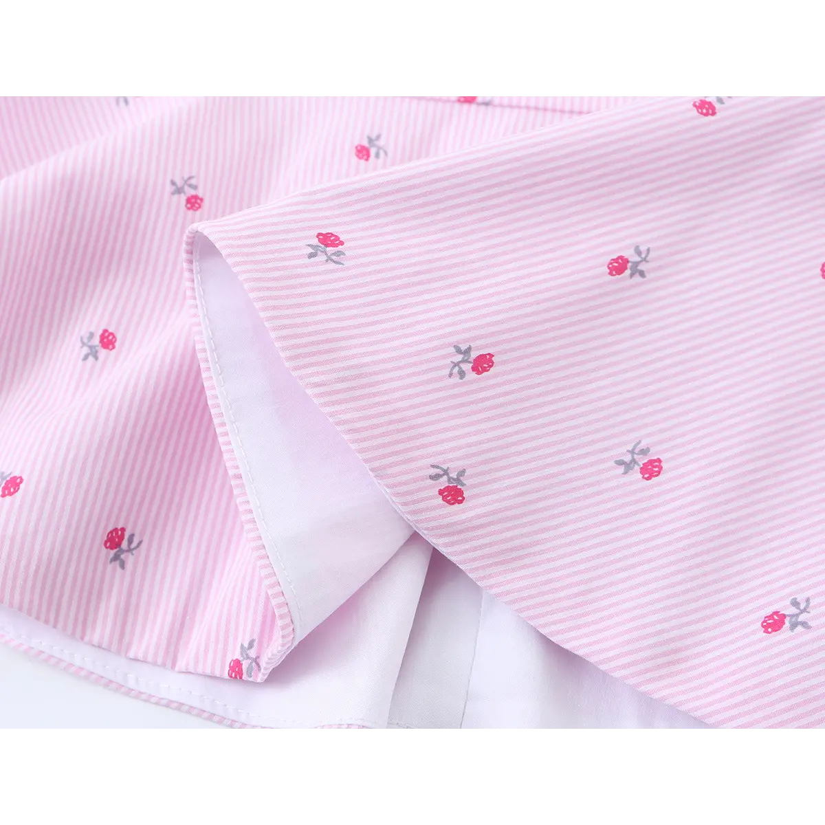 Close-up of the peplum hem, showing the white inner lining and the finished edge stitching.