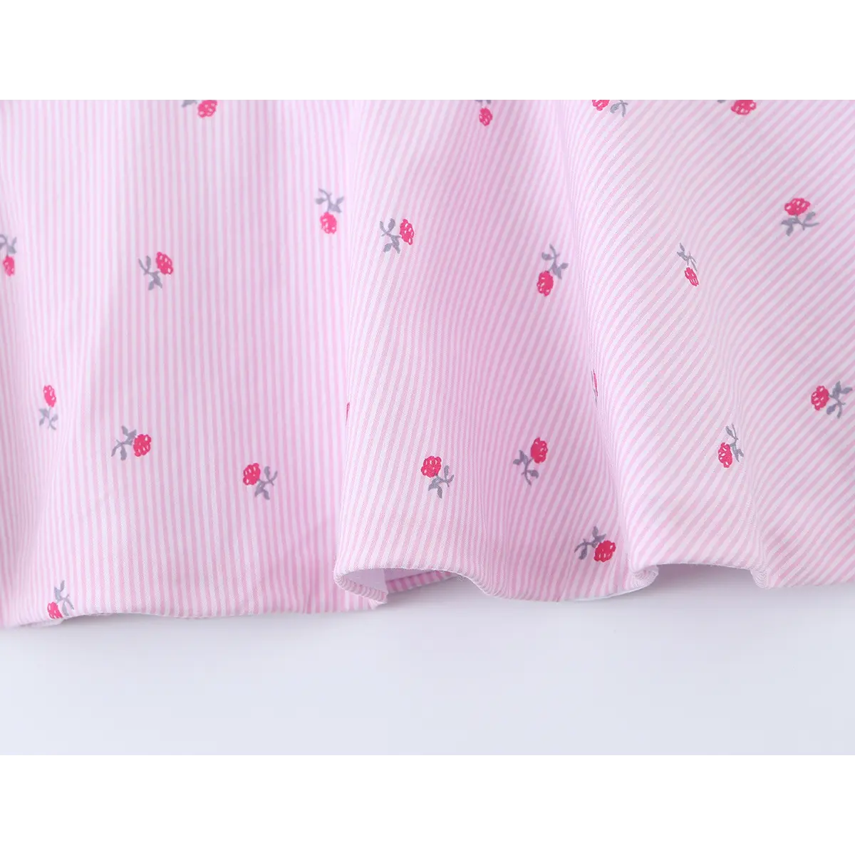 Close-up of the peplum skirt, showing how the fabric gathers at the waist to create volume.