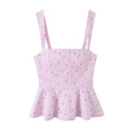 Front view of the same top, showing the square neckline, fitted bodice, and flared peplum hem.