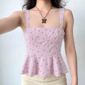 The peplum top styled on a model, showcasing its feminine silhouette and how it pairs with casual bottoms.
