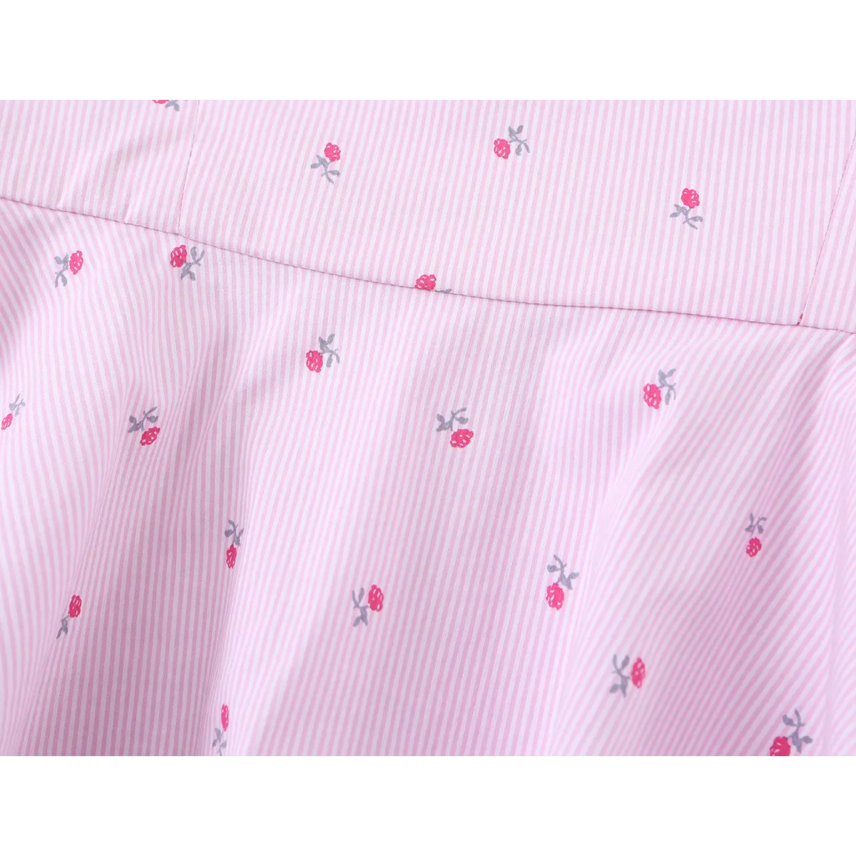 Close-up of the waist, showing the gathered transition from the bodice to the skirt.