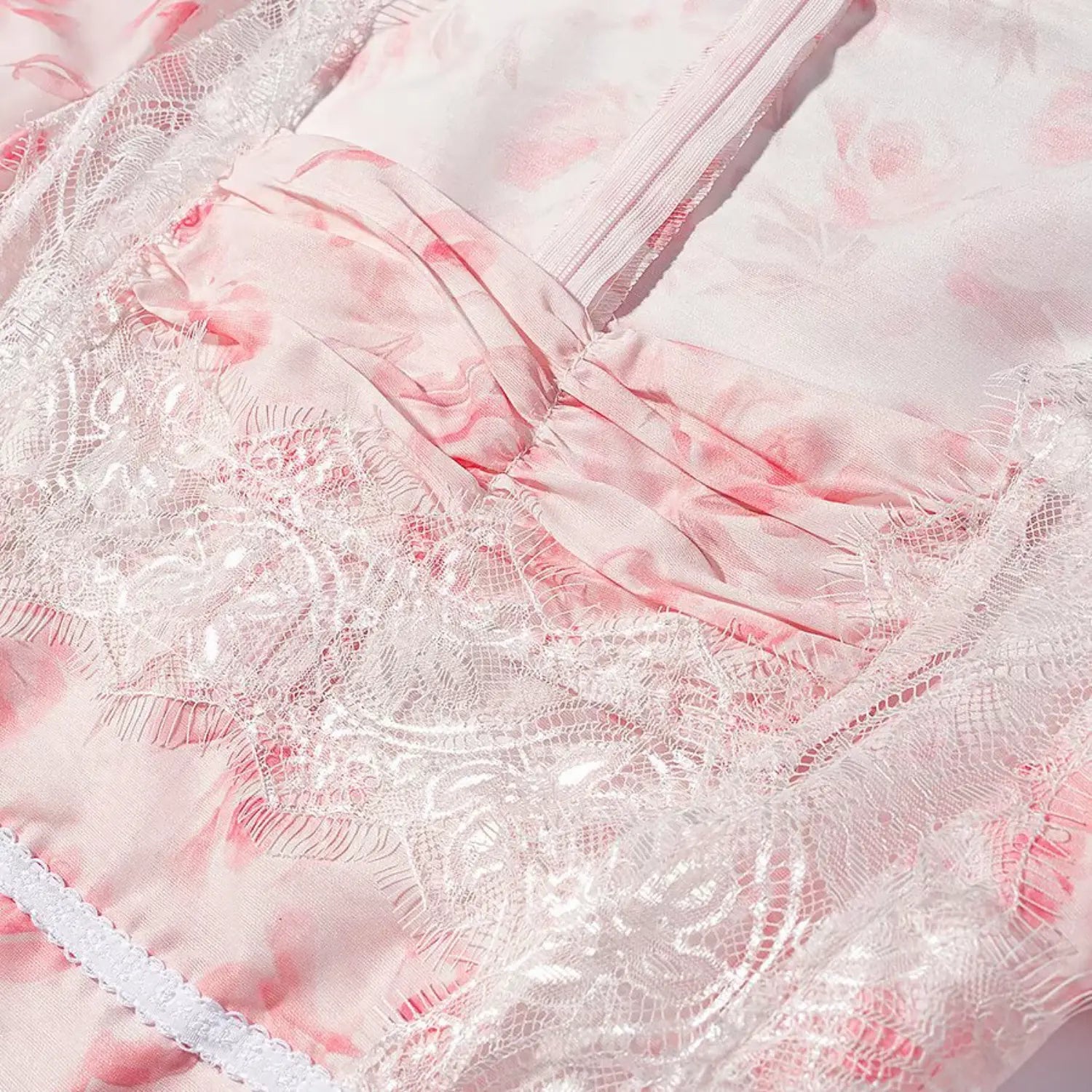 Macro shot ruched bust and sheer eyelash lace panel of pink floral peplum shirt