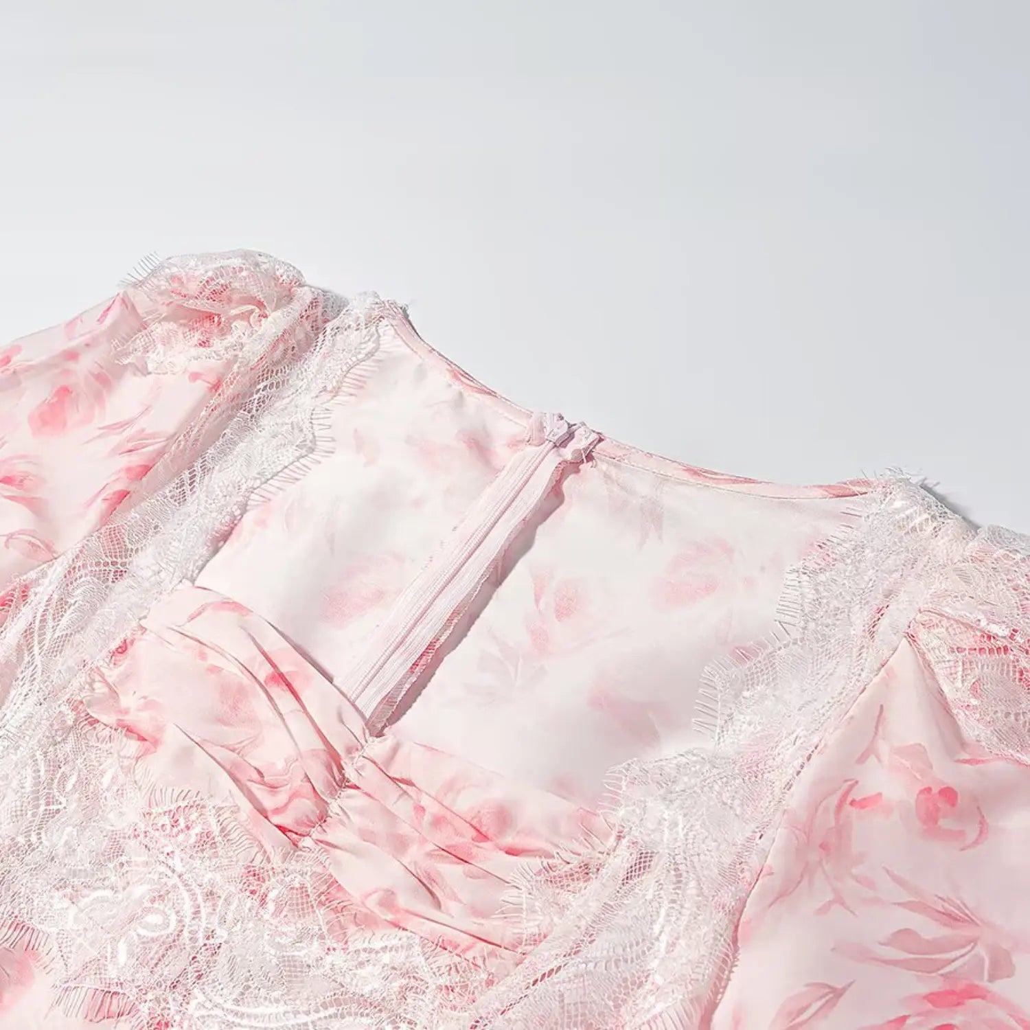 Close up square neckline white eyelash lace and front ruched detail on pink floral blouse