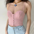Lifestyle shot of model wearing the pink gingham corset cami with light blue jeans, showing the sweetheart neckline and cropped fit