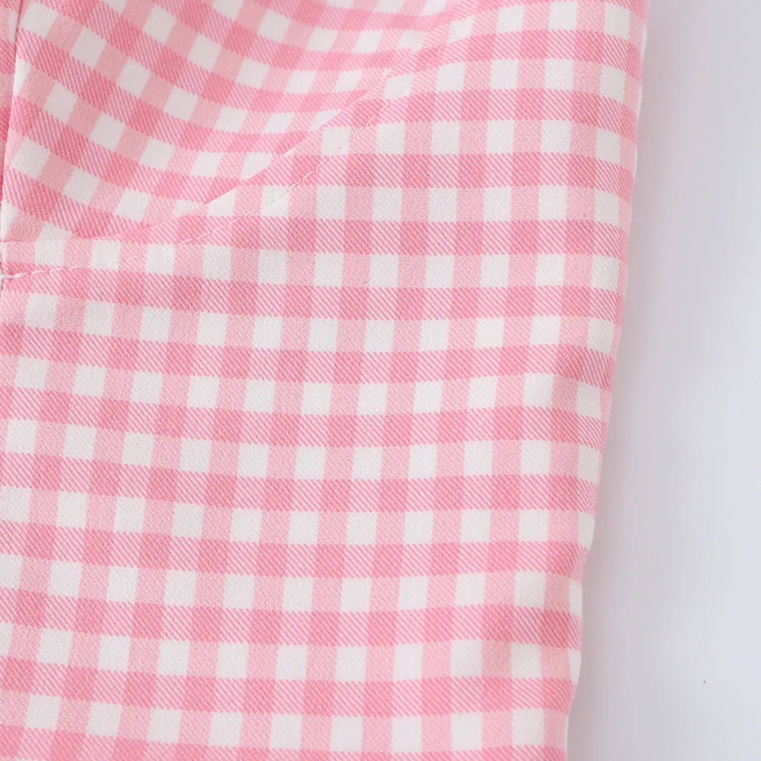 Close-up of the tailored side seams and darts on the pink gingham corset top