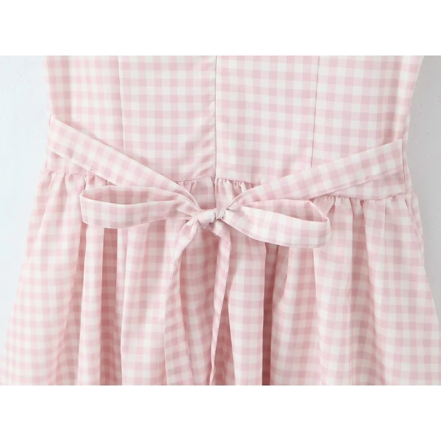 Close‑up waist self fabric tie bow back detail pink gingham midi dress