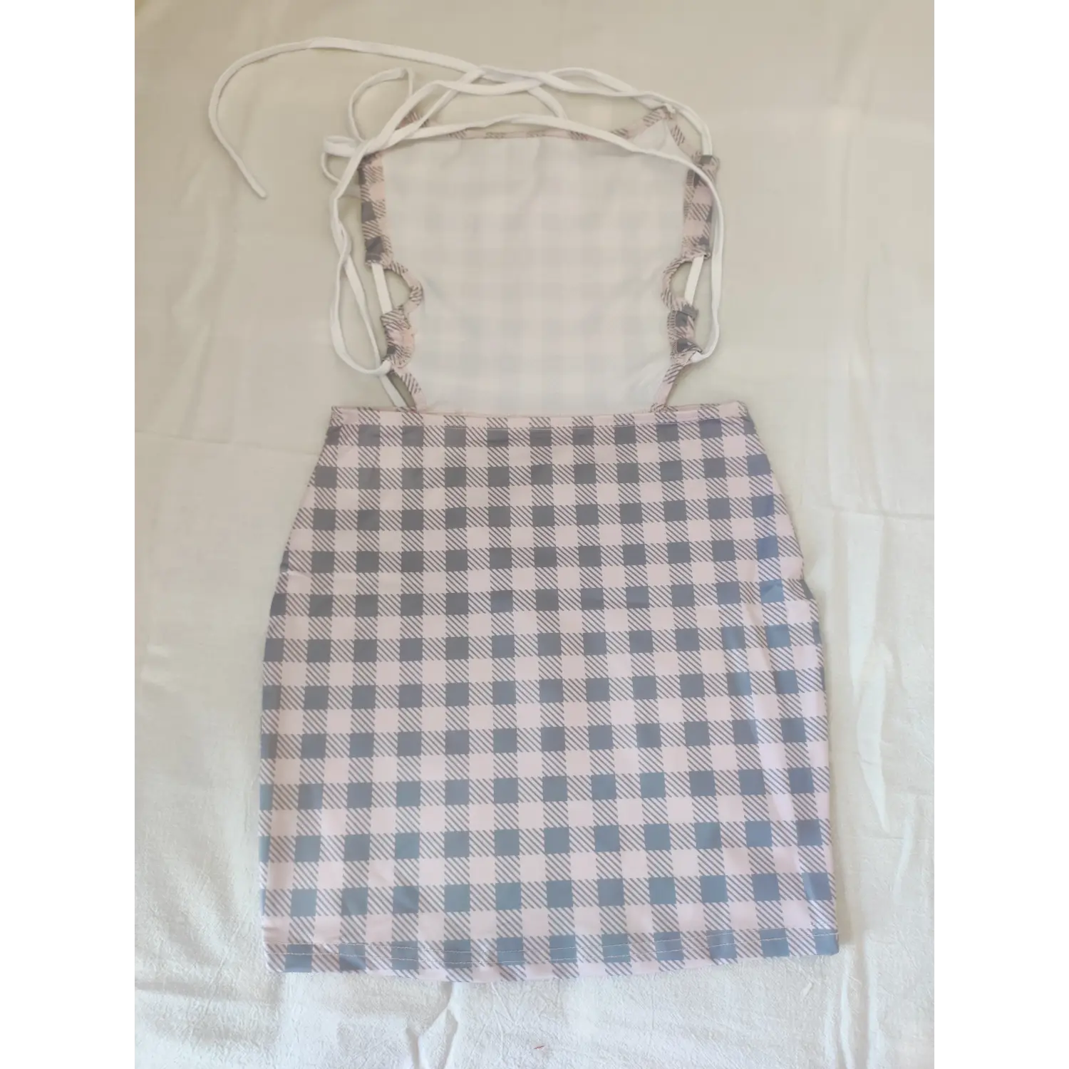 Backless pink gingham bodycon dress with tie halter straps, flat lay back view