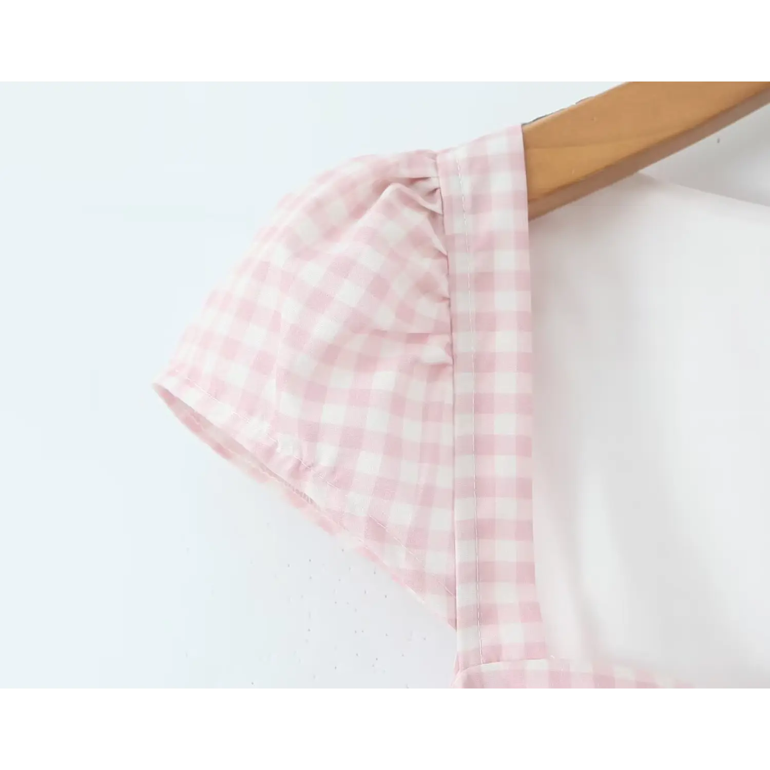 Close‑up cap sleeve gathered shoulder seam detail pink gingham midi dress