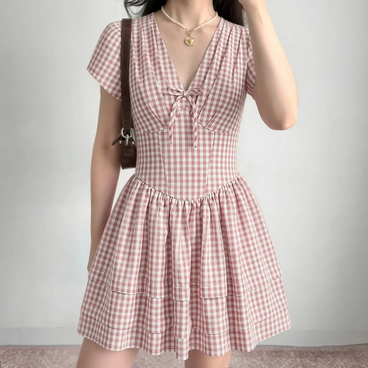 Lifestyle shot of front tie gingham mini sundress casual daily look