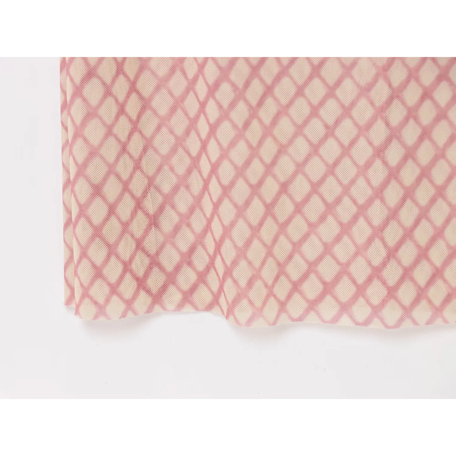Close-up shot of pink beige grid mesh fabric and skirt hem of slip midi dress