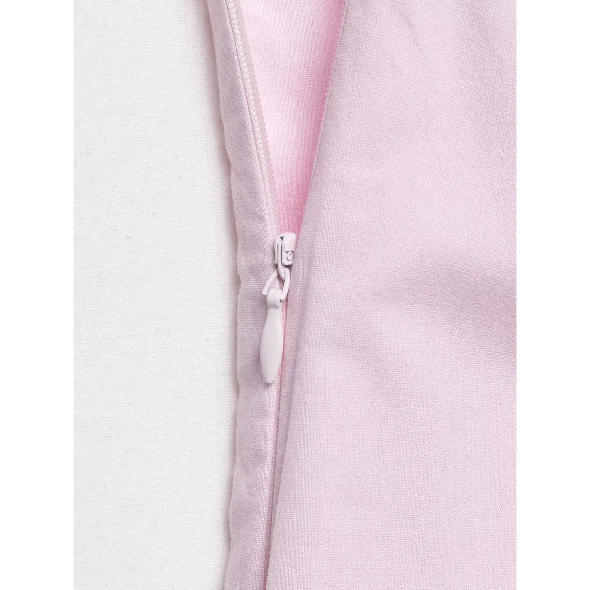 Close-up of the dress's side zipper with a matching pull.