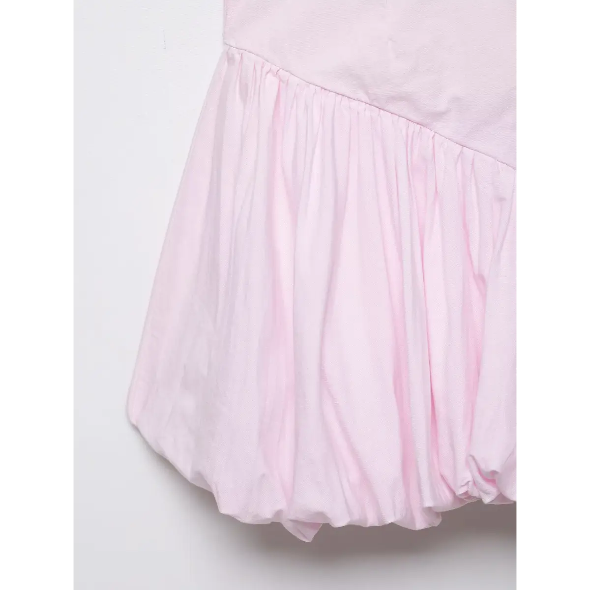 Close-up of the dress's gathered waist and bubble hem.