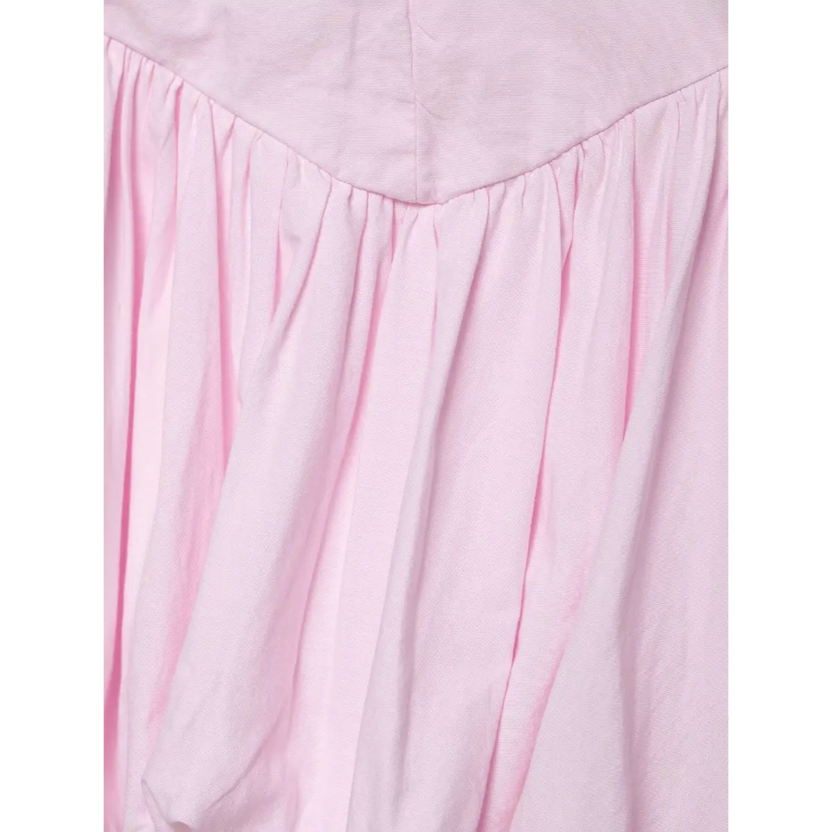 Close-up of the dress's V-shaped waist seam and skirt gathers.