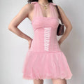 Studio model front shot pink halter corset mini dress with crisscross ribbon bodice and bubble tulle skirt