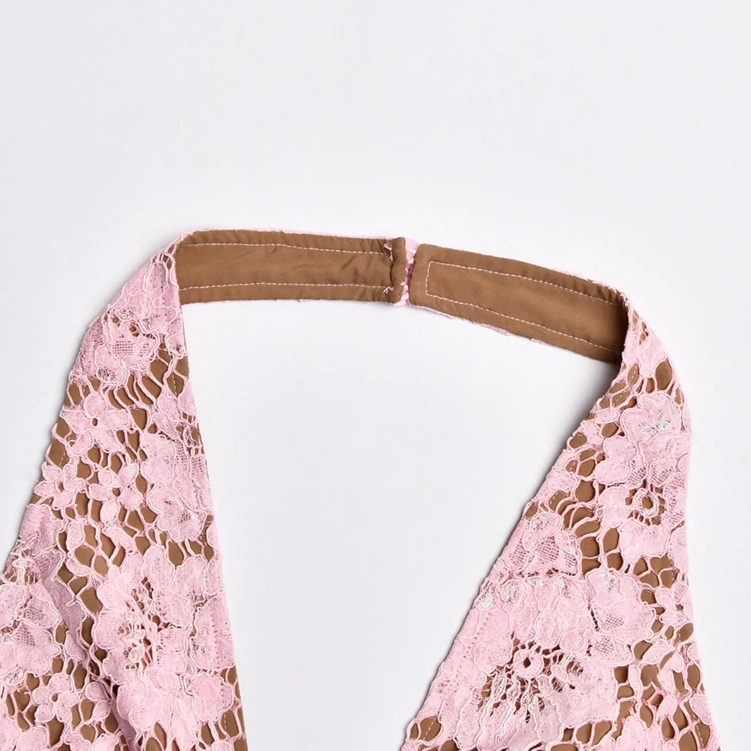 Close‑up inner lining and stitching detail of pink lace halter neck strap
