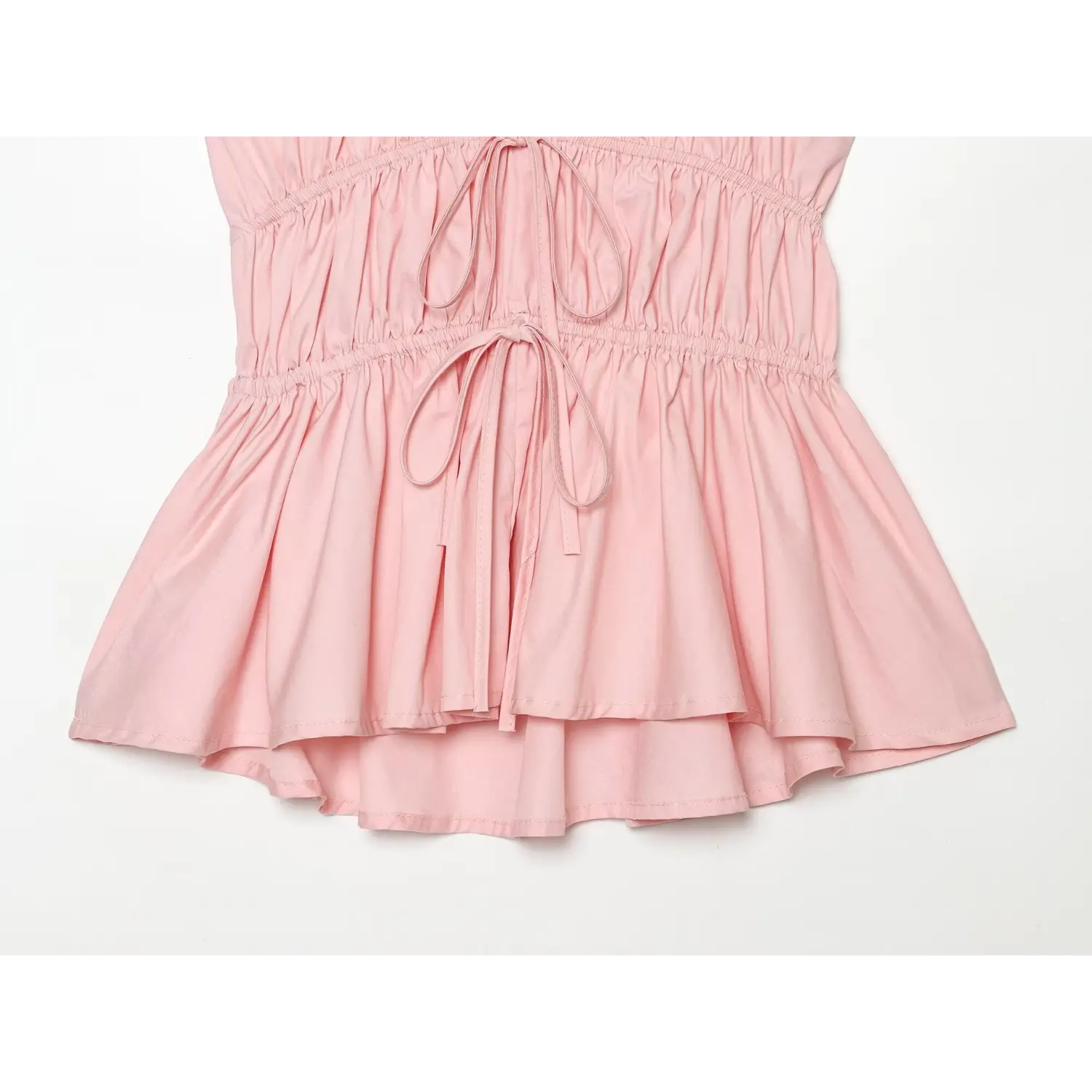 Close-up of layered peplum flared hem, uneven high-low tiered design