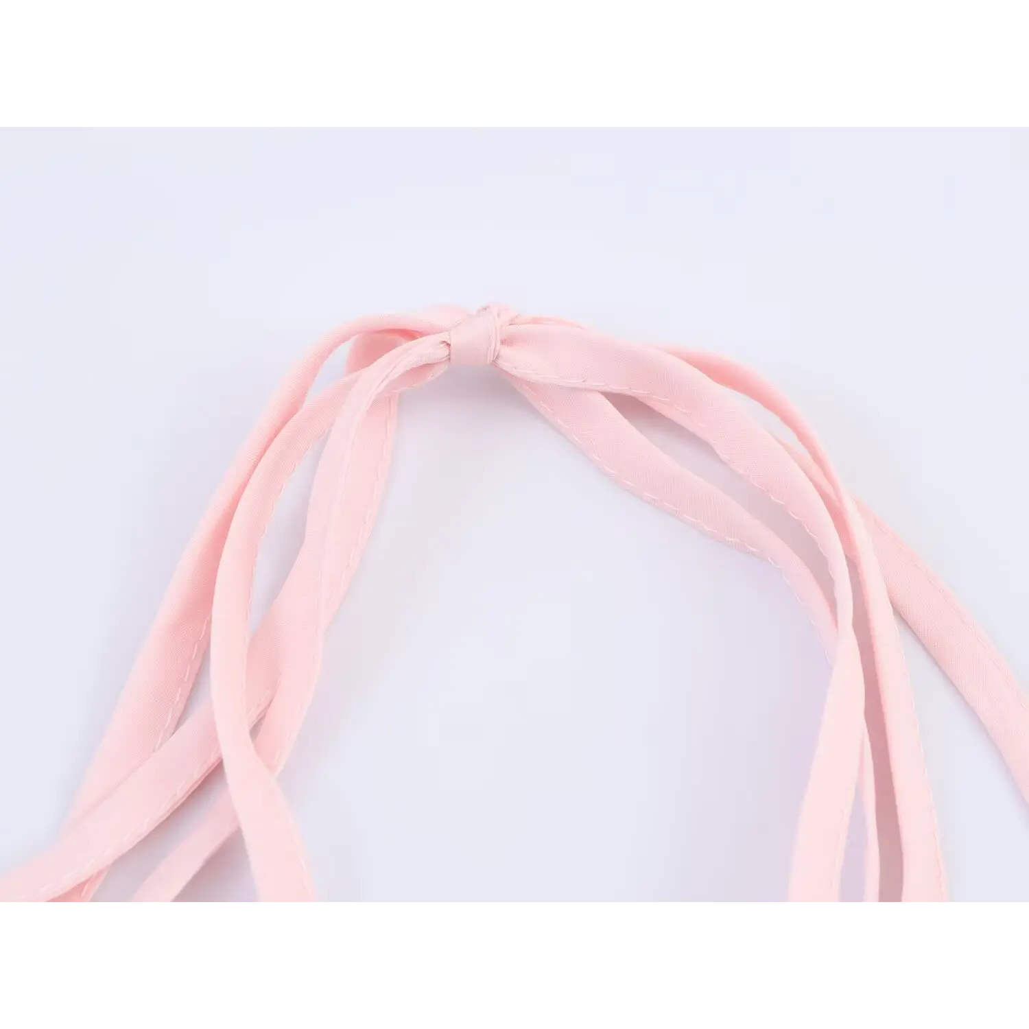 Close-up of wide matching pink self-fabric halter tie straps knotted at neck, smooth woven soft chiffon ribbon for back tie dress