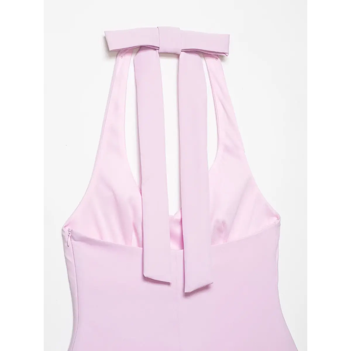 Full view of the top's back, showing the large bow at the neck and hanging fabric ties.
