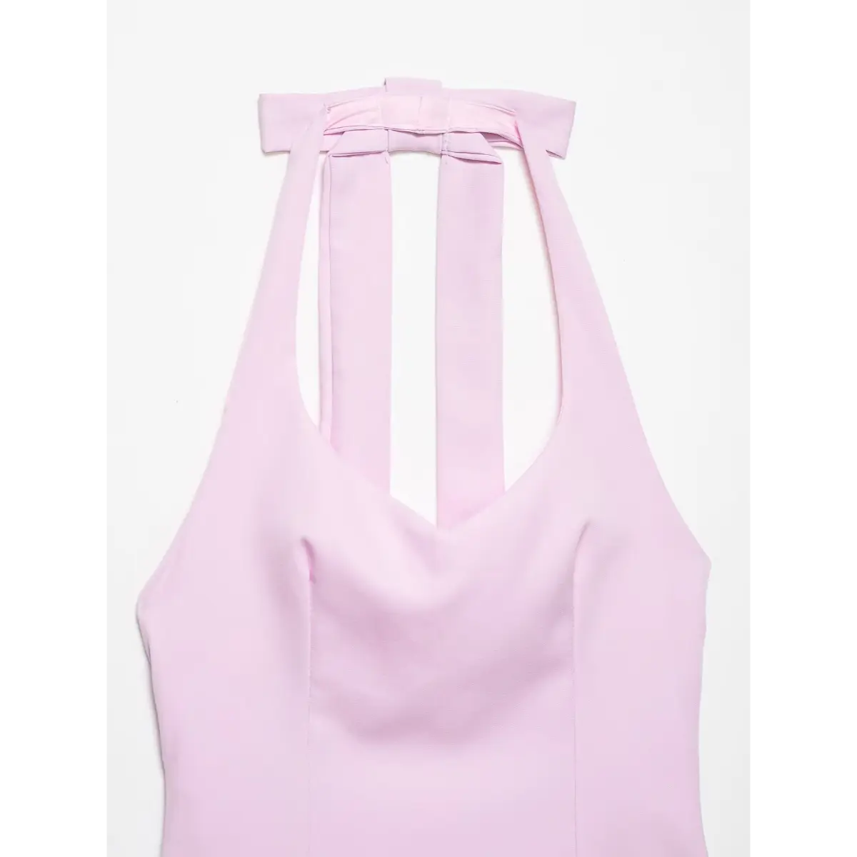 Close-up of the top's front neckline, showing the bow and strap construction.