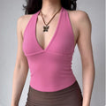 Hot pink halter top styled on a model, showcasing its deep V-neckline, body-hugging fit, and how it complements everyday bottoms.