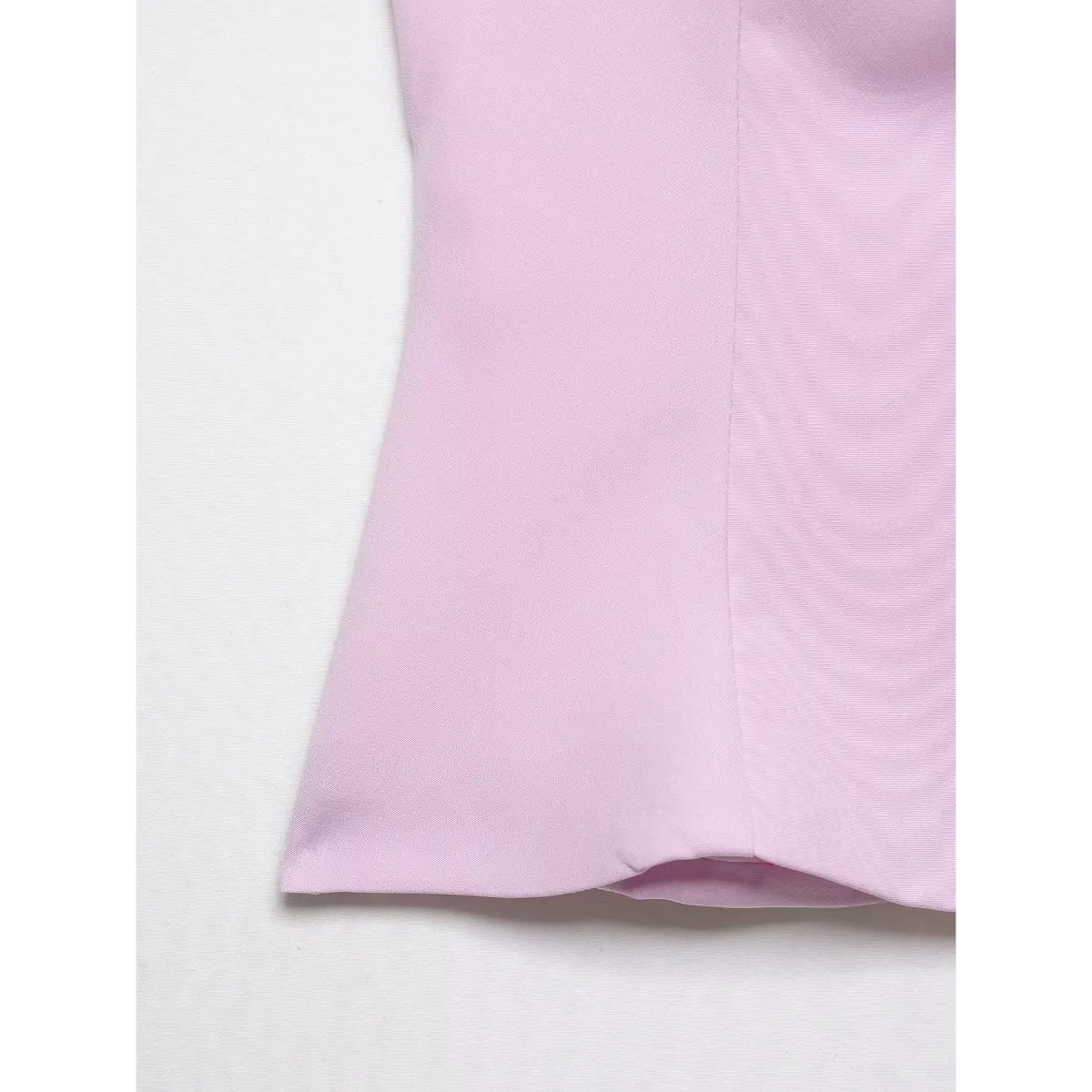 Close-up of the top's side seam, highlighting the fabric texture and tailored construction.
