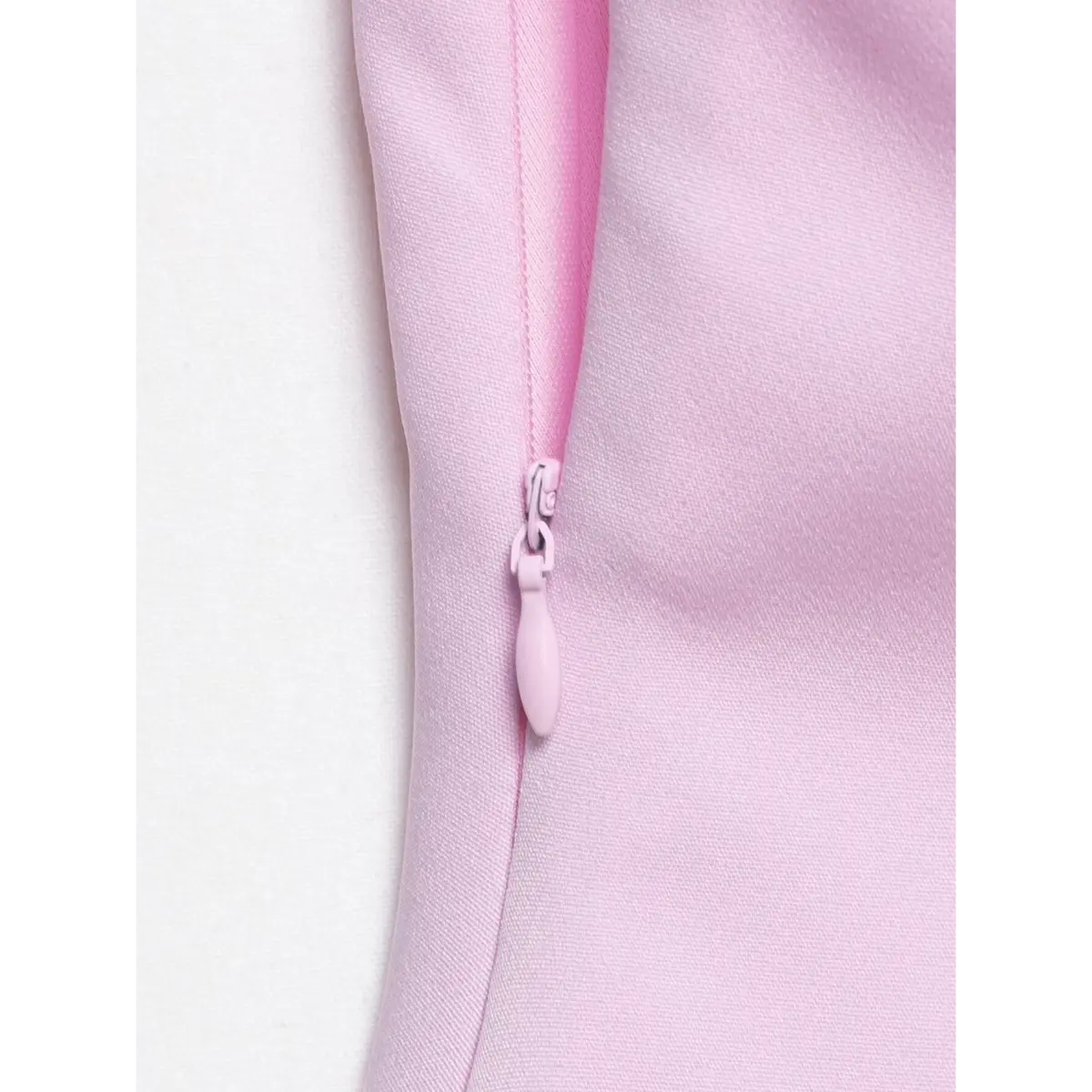 Close-up of the top's side zipper, showing the pink pull tab and matching fabric.