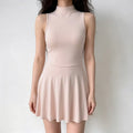 Model wearing pink high neck sleeveless skater dress, slim fit flared mini skirt, casual elegant style