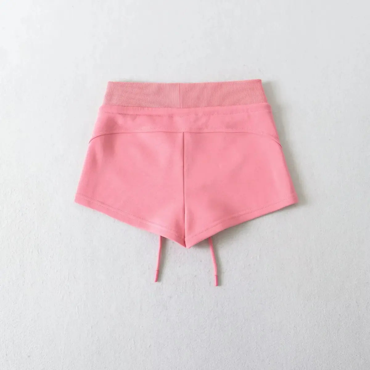 Back view of pink high-waisted drawstring shorts, showing the clean seam design.