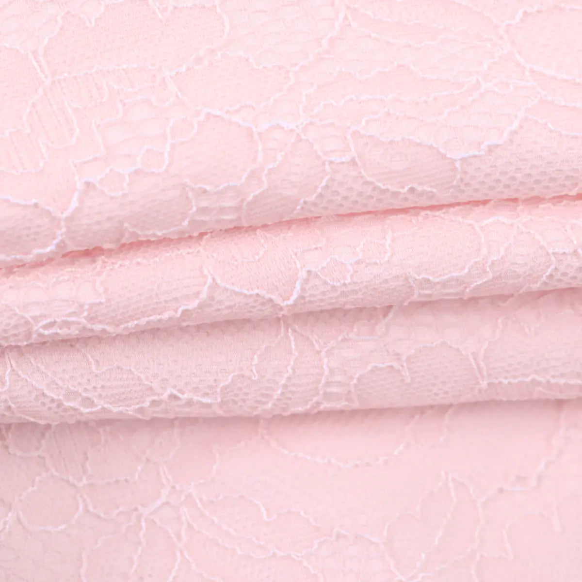Close-up of the pink lace fabric, showing the intricate floral pattern and texture