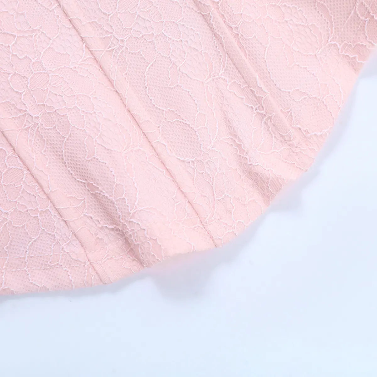 Side view of the pink lace bustier top, showing the vertical boning and floral lace pattern