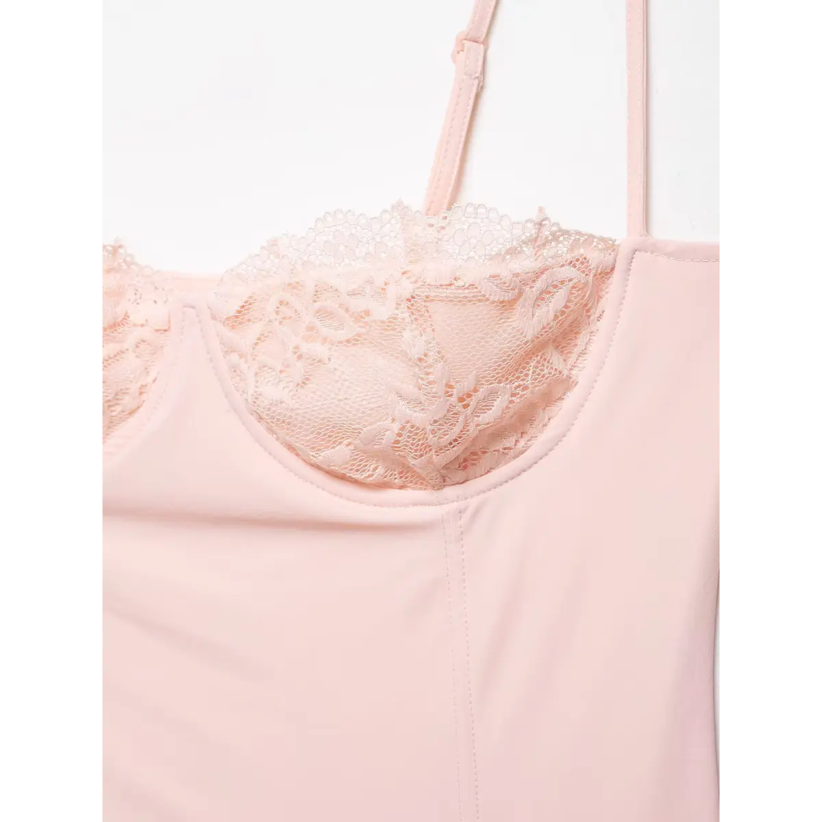Close-up of the scalloped lace bust cup, featuring the floral pattern and smooth fabric overlay.