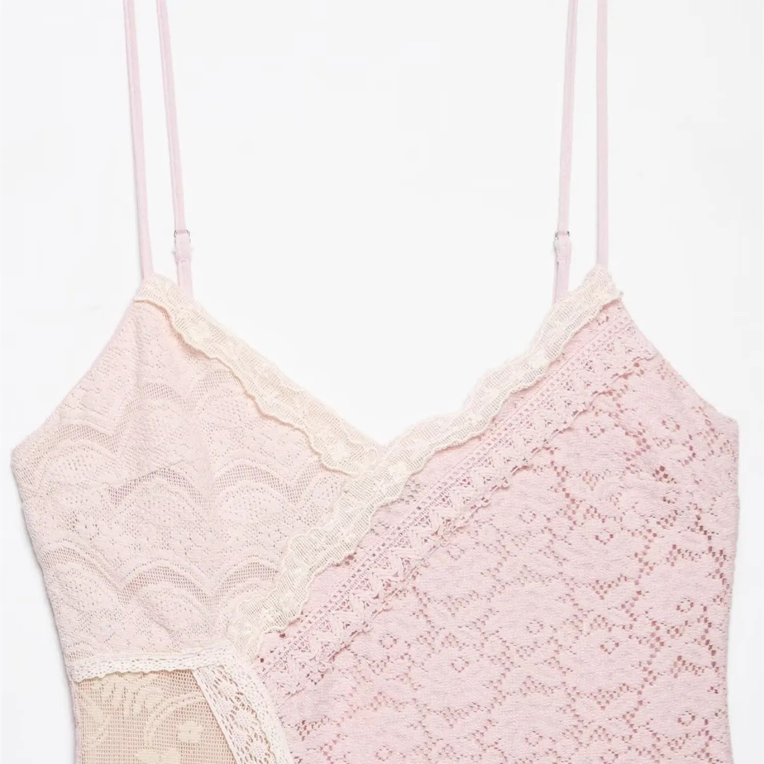 Close-up shot isolated white background, scalloped contrast off-white lace trim V-neck detail of pink spaghetti strap lace mini dress