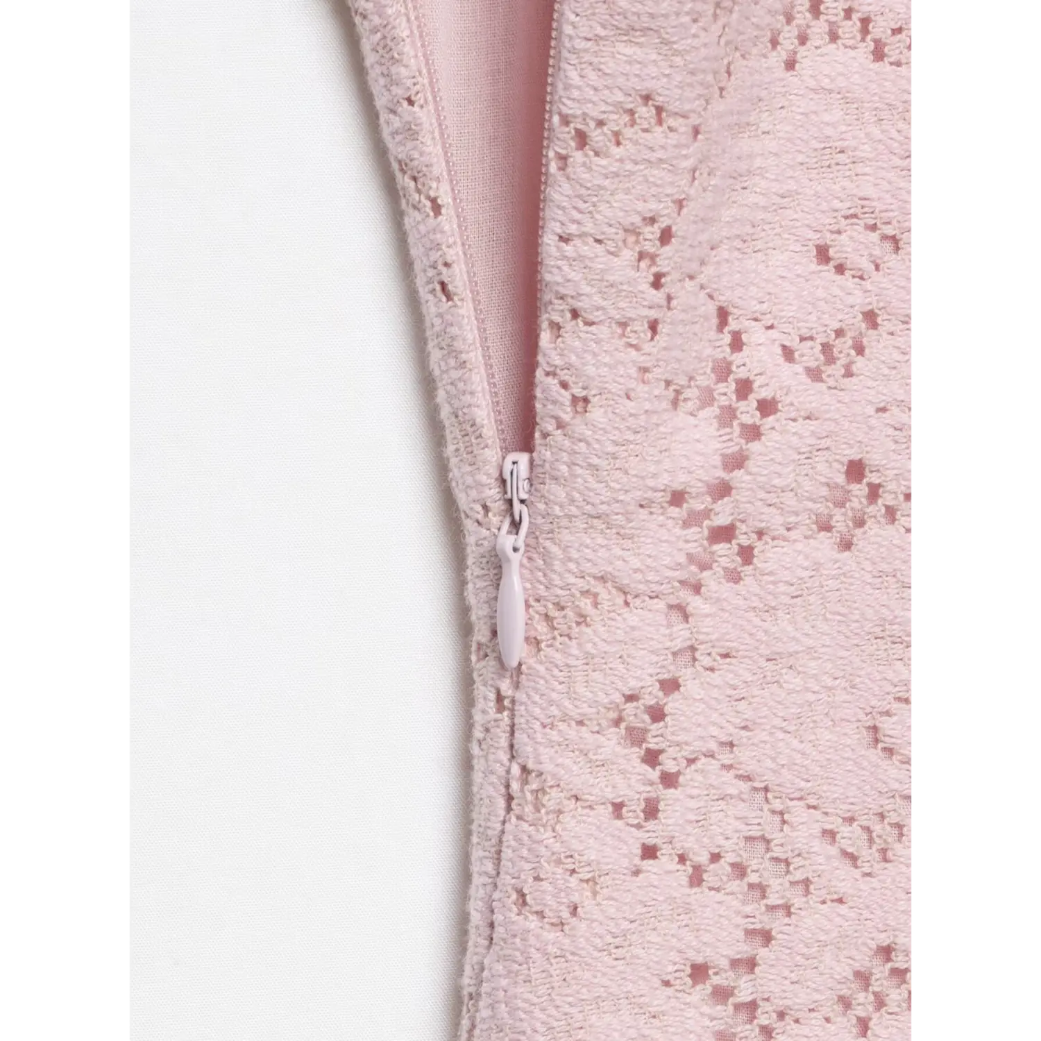 Close-up isolated white background, hidden invisible side zipper detail on pink floral lace cami mini dress