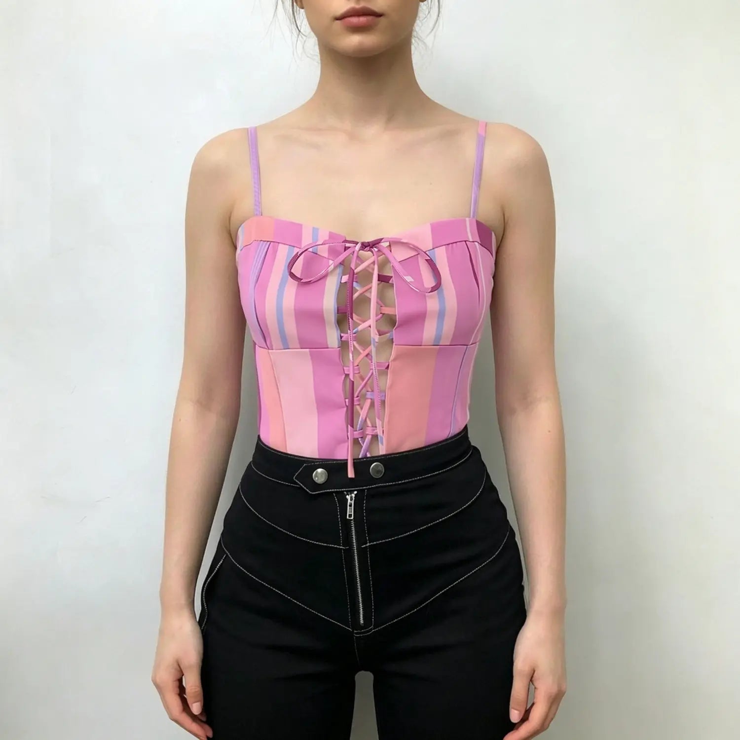 Model wearing pink lavender vertical stripe corset cami top, front lace‑up closure, fitted waist