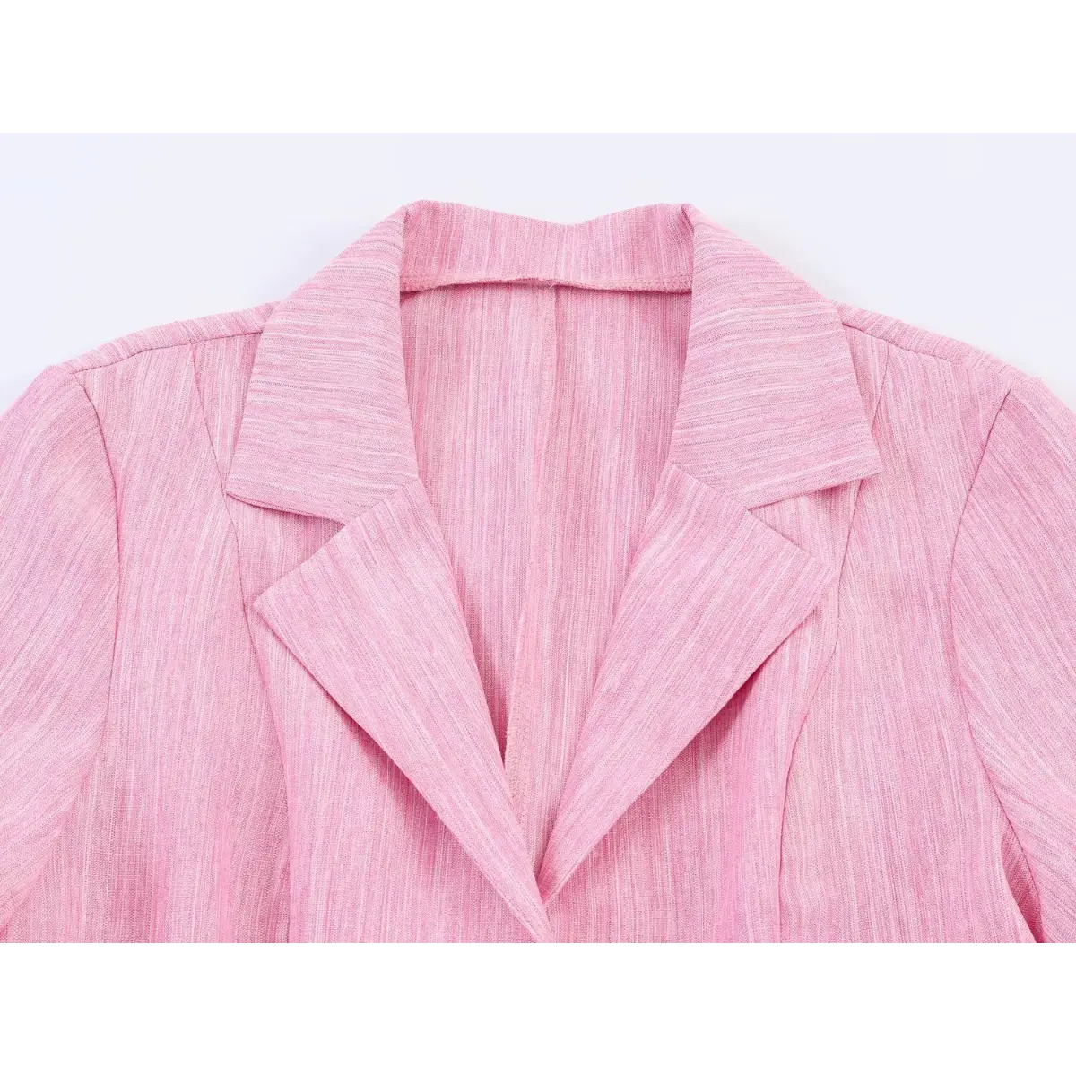  Close-up view of the notched lapel and collar on a pink linen blazer dress, showing the sharp tailoring and fabric texture.