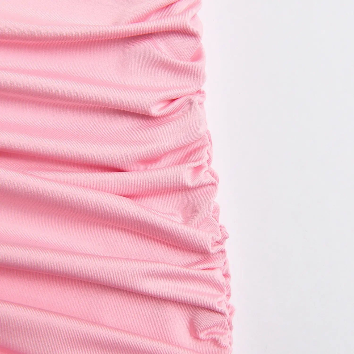 Close‑up side ruched gathering detail on pink waist skirt panel