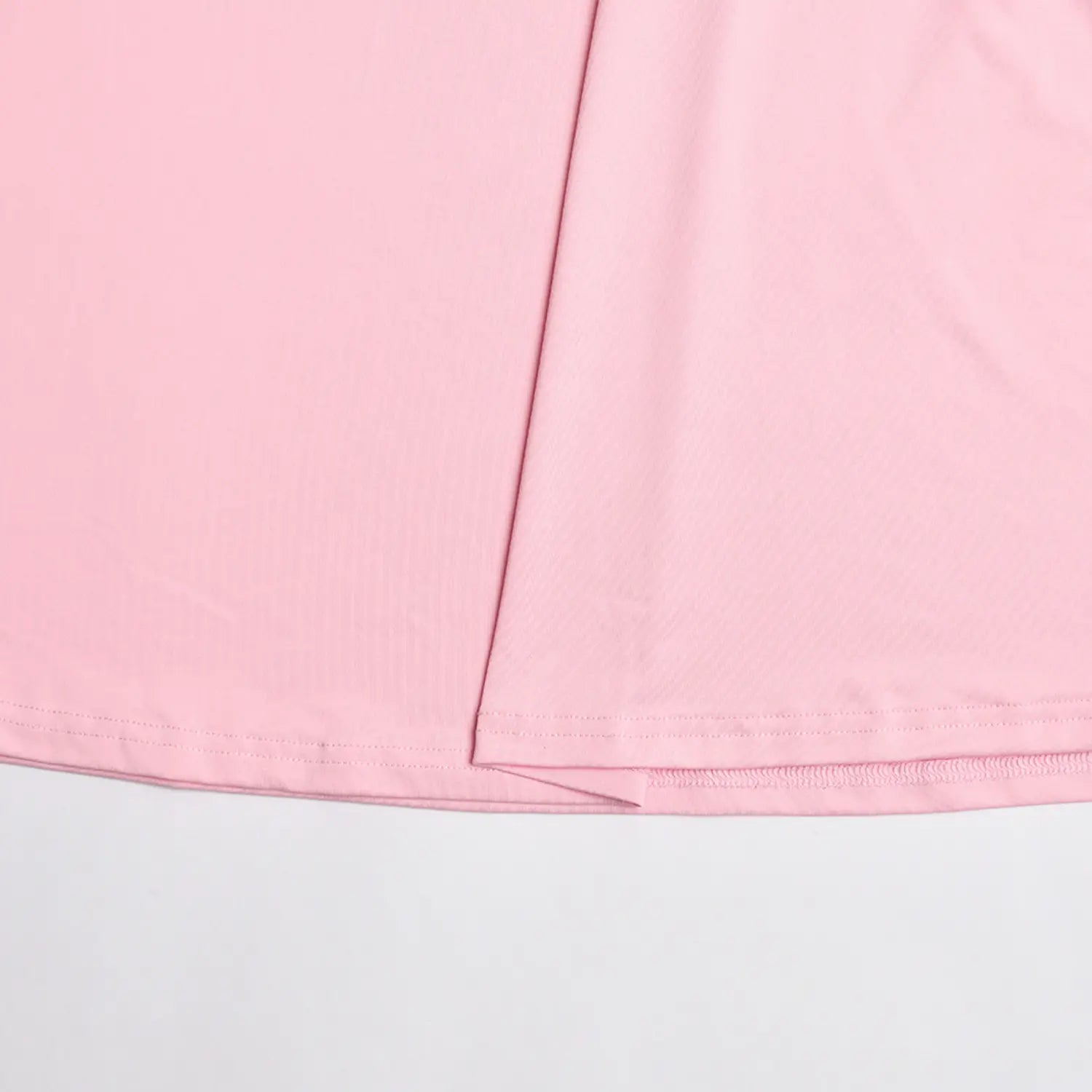 Close‑up finished hem stitching of pink mermaid long skirt